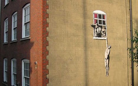 banksy bristol man hanging out of window
