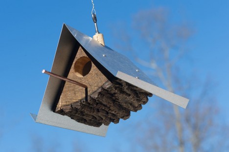 log metal birdhouse below