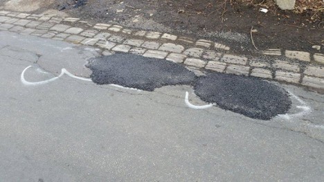 wanksy filled pothole